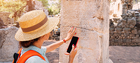 A student examining an ancient stone with writing