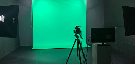 Camera in front of a green screen inside the Digital Arts and Visualization Space