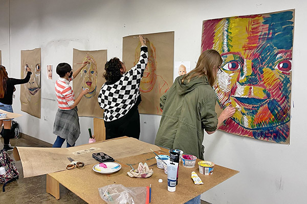 Art students working on their painting projects in studio