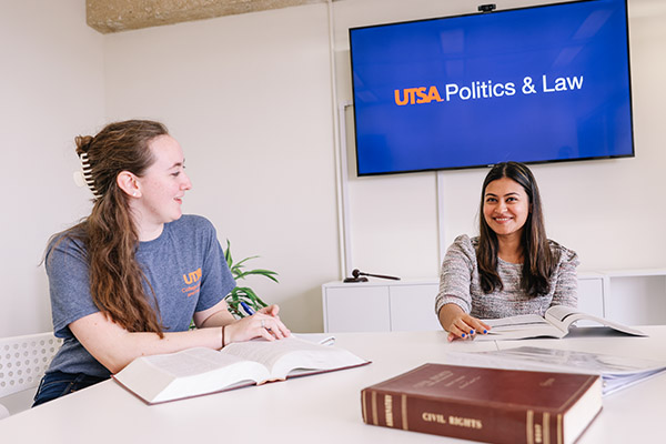Political science students in a study room reading their textbooks