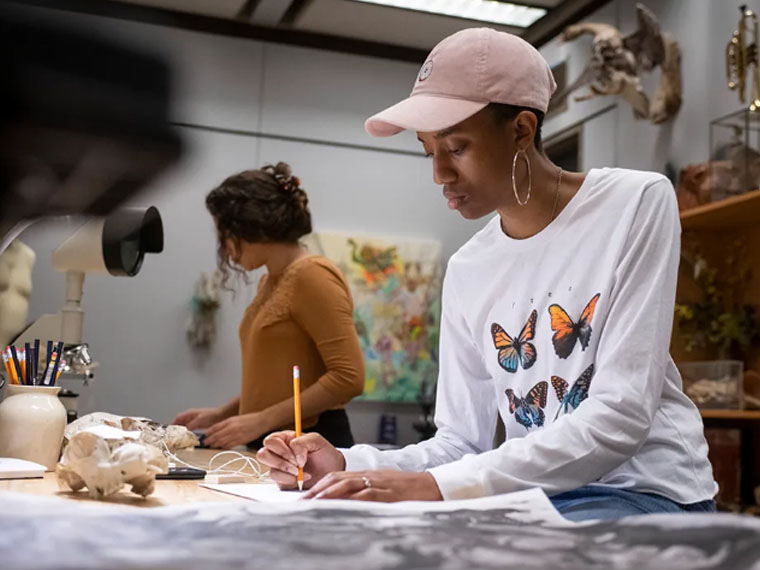 Anthropology student in butterfly shirt studying 