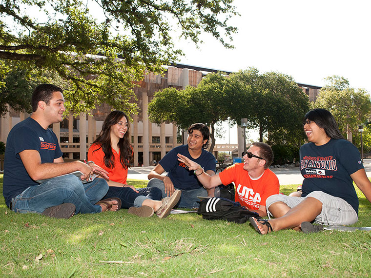 UTSA students speaking on a lawn