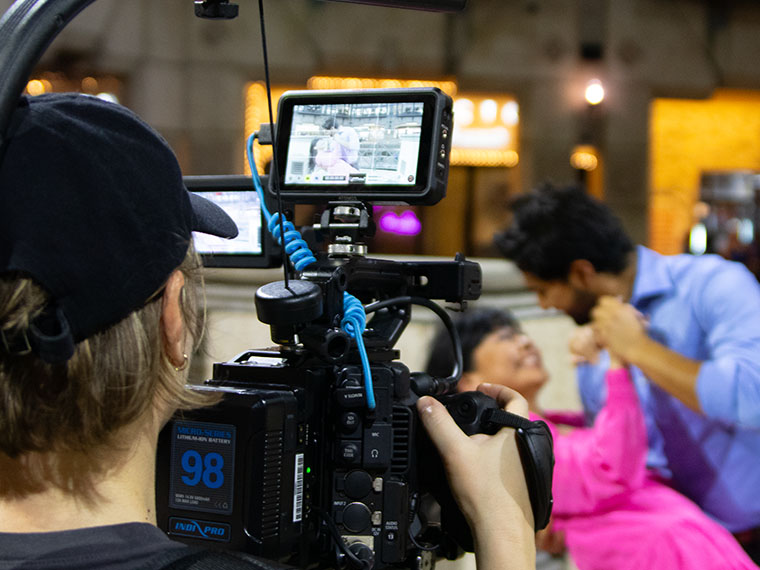 male student filming a couple