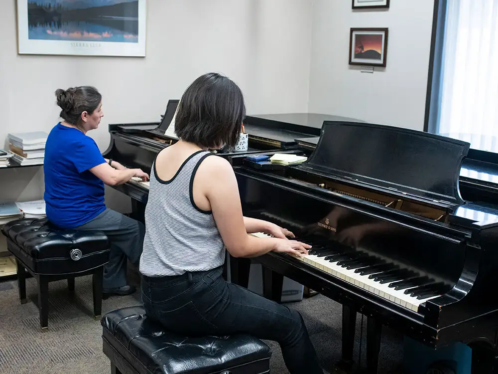 Two students using pianos