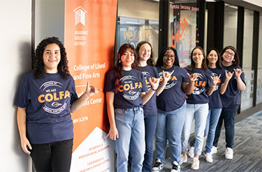 Peer educators next to SSC banner 