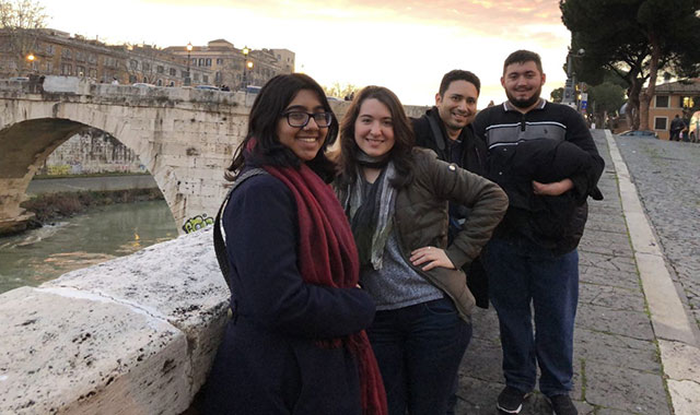 Group of students next to Arch on Tiber River at Sunset