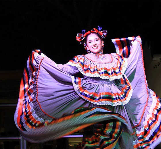 A member from Ballet Folklórico de UTSA dances at the Light the Paseo event on Main Campus.