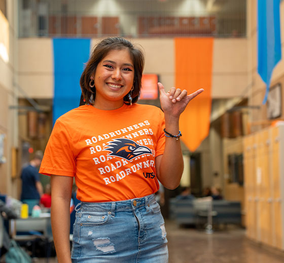 Student showing a Birds Up hand sign