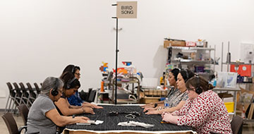 People sitting at a sound installation 