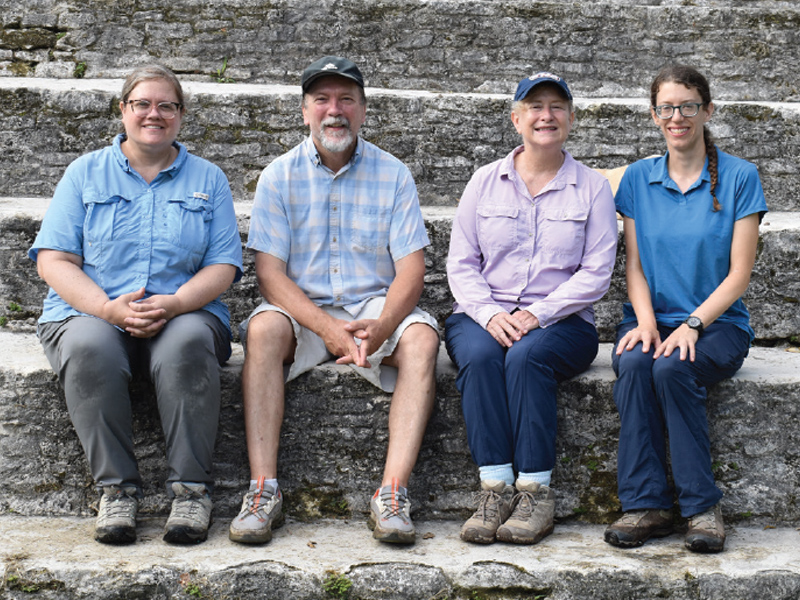 aeger and Brown (center) flanked by project Associate Directors, Bernadette Cap (left) and Rachel Horowitz (right) on the stairs of the main acropolis at the Maya site of Xunantunich, Belize.
